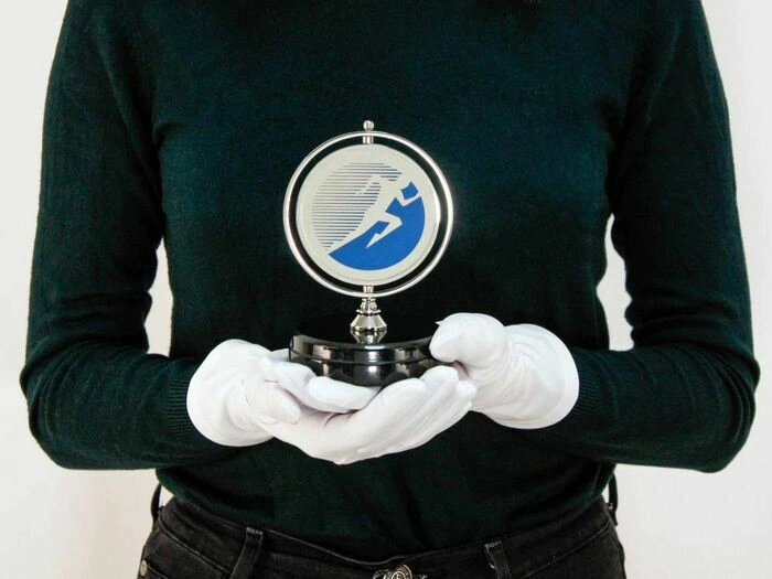A medal spinning on a stand